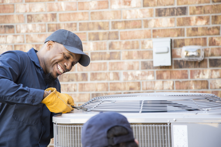 hvac tech repairing hvac unit