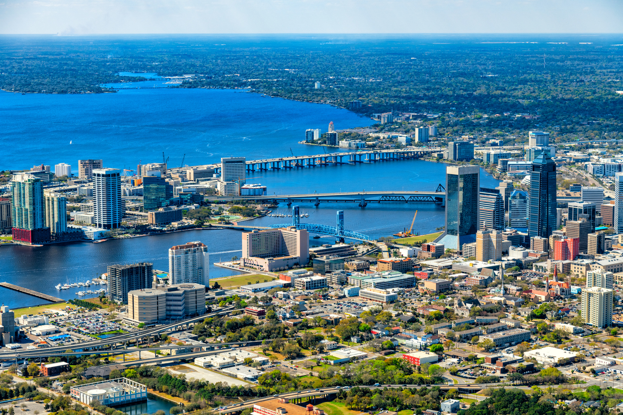 The urban skyline of Jacksonville, Florida, with the St. John's River dividing the city.
