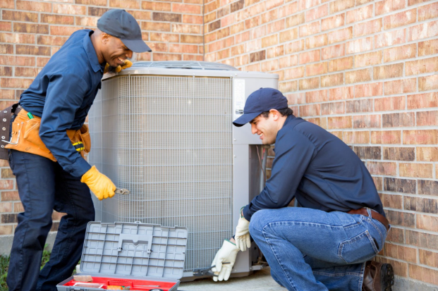 HVAC workers outdoors working on an HVAC unit